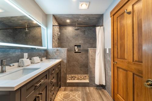 a bathroom with a sink and a shower at Springs by Summit County Mountain Retreats in Keystone