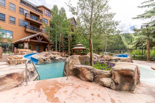a swimming pool in a yard with a resort at Springs by Summit County Mountain Retreats in Keystone