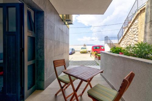 a table and chairs on a balcony with a view of the ocean at Villa Panorama in Senj