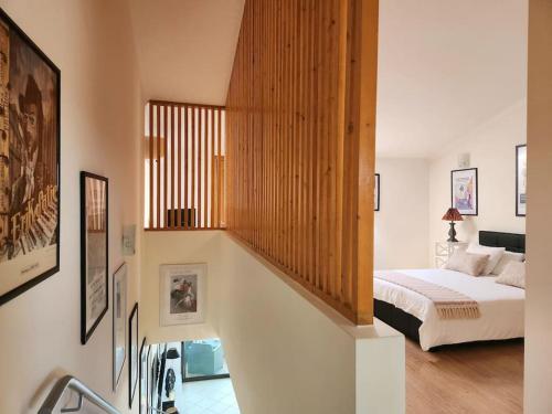 a bedroom with a bed and a staircase in a room at Maison de charme, Olhos de Água, Albufeira in Roja- Pé