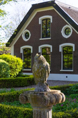 a stone lion statue in front of a house at Boerenhofstede de Overhorn in Weesp