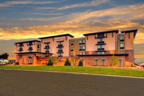 a large building on the side of a street at SpringHill Suites by Marriott Bozeman in Bozeman