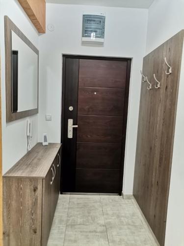a bathroom with a black door and a sink at T lux apartman in Kragujevac