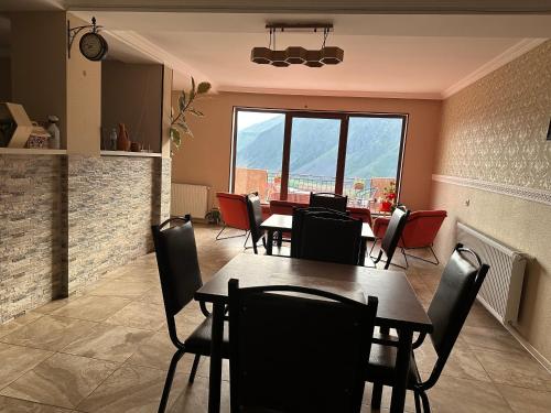 a dining room with a table and chairs at Apartment Nikolo in Stepantsminda