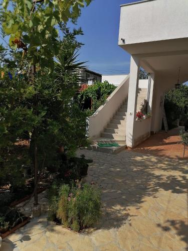 a stairway leading to a house with a stair case at Apartman Lucija in Murter