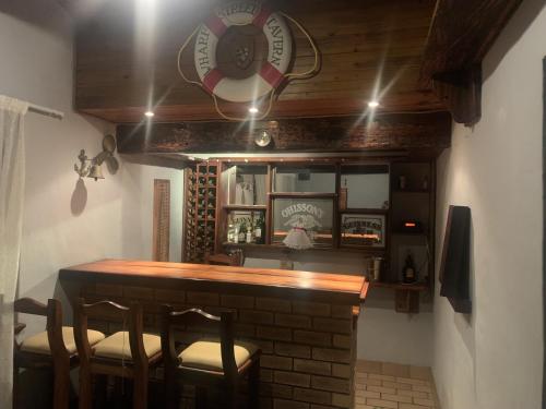 a bar with chairs and a clock on the wall at Maisha@Toti in Amanzimtoti