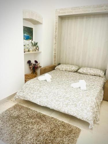 a bedroom with a bed with two towels on it at ACANTHUS in Terlizzi