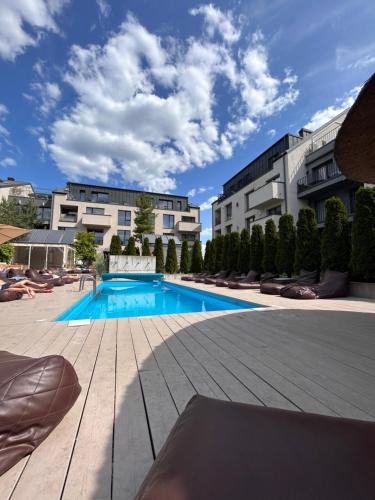 a swimming pool in the middle of a building at Super mini loft with outdoor pool. in Palanga