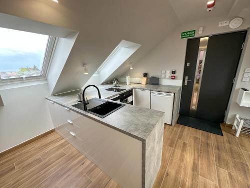 a kitchen with a sink and a counter top at Pod Czwórką in Rewa