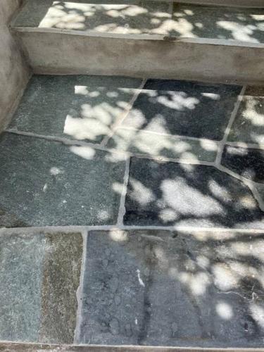 a shadow of a tree on a stone floor at Dream House Little Villa - Amorgos in Amorgos