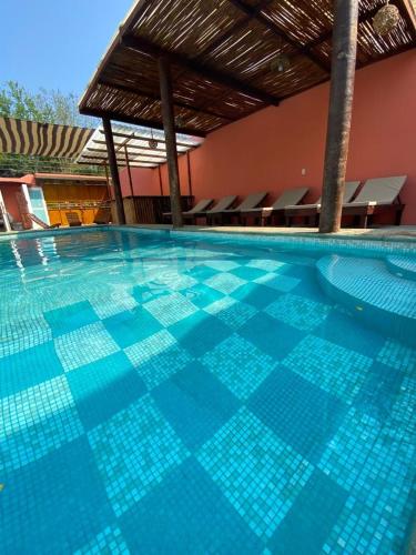 uma grande piscina com azulejos azuis em Casa Suites Minizoo em Puerto Escondido