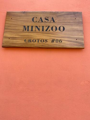 a wooden sign on the side of a building at Casa Suites Minizoo in Puerto Escondido
