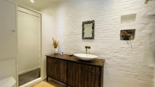 a bathroom with a sink and a white wall at ApartmentInCopenhagen Apartment 1541 in Copenhagen