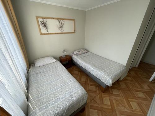 En eller flere senge i et værelse på Acuña & Donoso Apartamentos Centro