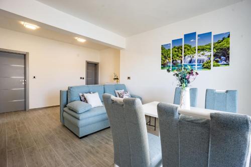 een woonkamer met een eettafel en stoelen bij Bepo Apartments at beach in Metajna