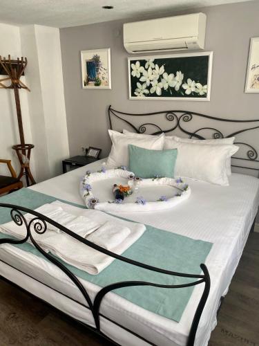 a bedroom with a bed with white and blue pillows at Bertiz Mignon in Bozcaada