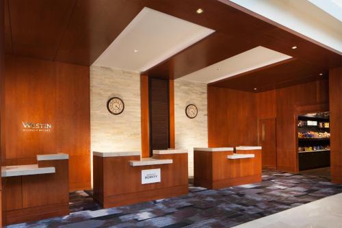 a lobby with wooden walls and clocks on the wall at The Westin Princeton at Forrestal Village in Princeton