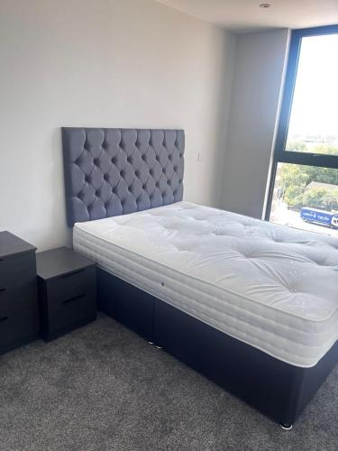 a bedroom with a large bed and a window at Executive Luxury stays 3 in Barking