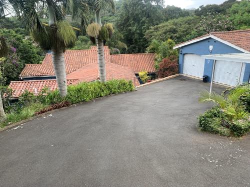a driveway in front of a house with a garage at Maisha@Toti in Amanzimtoti