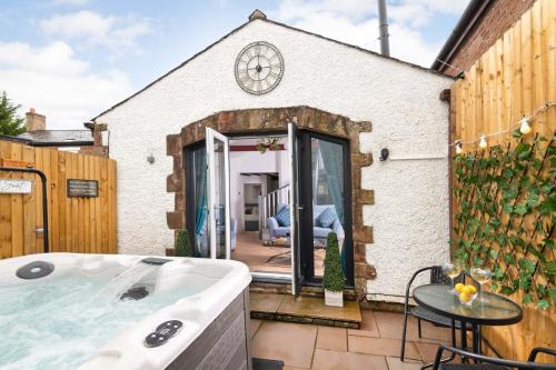 a bath tub in the backyard of a house at Cottage - Sleeps 3 hot tub & pet friendly in Brampton