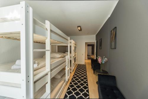 a room with three bunk beds in a house at The Harbour Apartment 2 in Hamburg