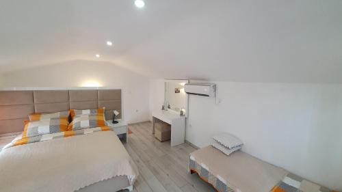 a bedroom with a large bed and a desk at Sea side apartment in Kotor