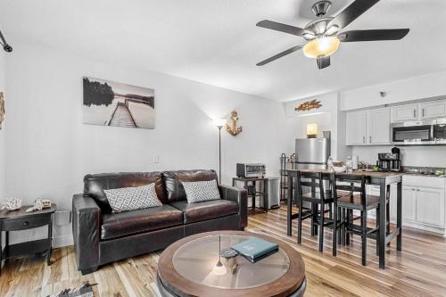 a living room with a couch and a table at Beso del Sol Resort in Dunedin - Perfect Location & Relaxation! in Dunedin