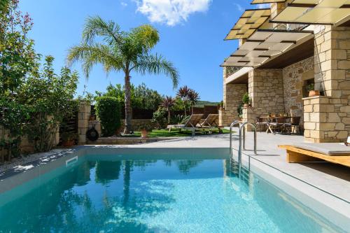 a swimming pool in a yard with a house at Effrosini Traditional Home in Nopíyia