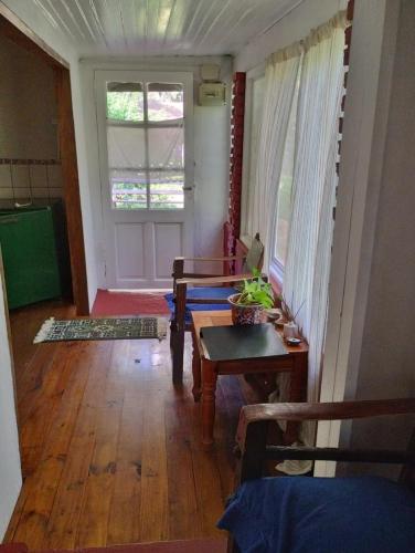a living room with a table and a window at Isla Pupe in Tigre