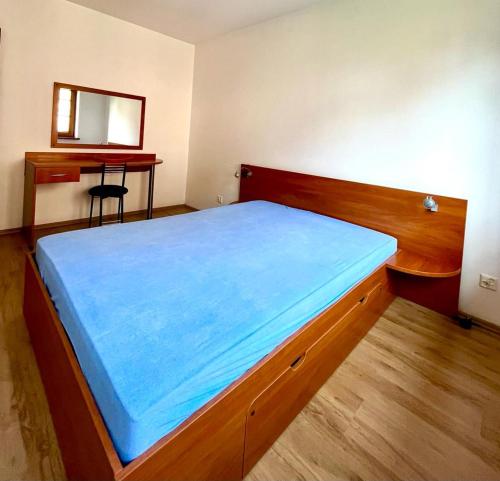 a bedroom with a bed with a blue sheet on it at Willa Julia in Karwia