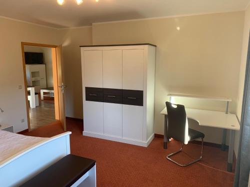 a bedroom with a desk and a desk and a chair at Hotel am Untersee in Bantikow