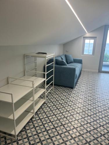 a living room with a blue couch in a room at B&B Vista Mare in Rodi Garganico