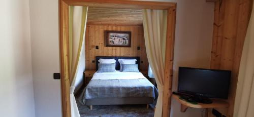 Ένα ή περισσότερα κρεβάτια σε δωμάτιο στο Hôtel-Chalet Les Ecureuils Restaurant, Piscine, Jardin Garage