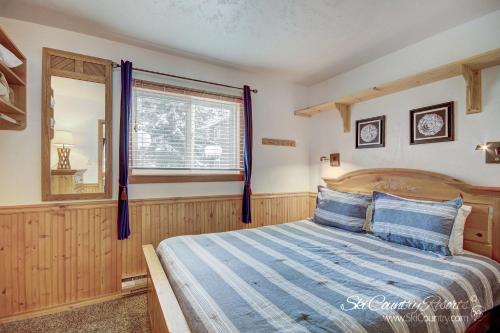 a bedroom with a bed and a window at Affordable Breck Getaway with Recent Updates, Spacious Lobby, Outdoor Hot Tubs PM2B in Breckenridge