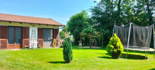 a yard with a house and a swing at STARE BENE B&B in Bernezzo