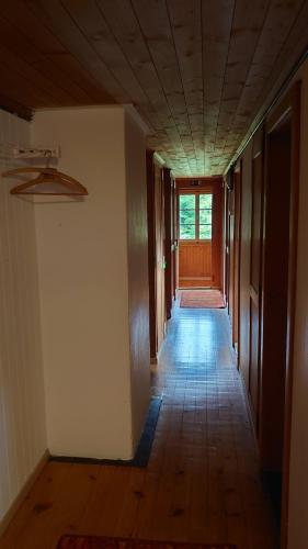 an empty hallway with a hallway leading to a door at Kunst- und Naturfreundehaus Brünig in Lungern