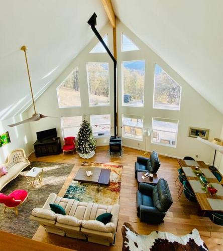 a large living room with couches and a christmas tree at Modern House on 5 acr in Sequoia National Forest in Panorama Heights