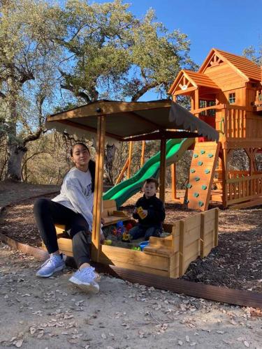 a woman and a child sitting in a play house at Modern House on 5 acr in Sequoia National Forest in Panorama Heights