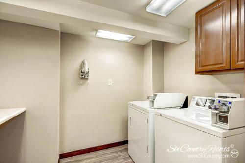 a kitchen with a white refrigerator and a microwave at Affordable and Cozy Condo Steps from Main Street with Spacious Lobby, Hot Tubs PM3B in Breckenridge