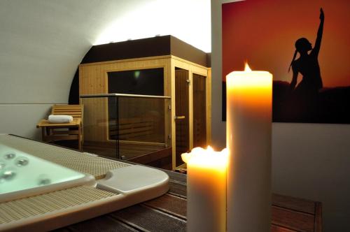a room with a candle and a woman jumping on a bed at Grand Hotel Piazza Borsa in Palermo