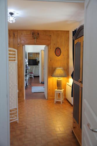 a hallway with a living room with a table and a lamp at Gîte Edelweiss Saint-Martin-en-Vercors in Les Barnoux