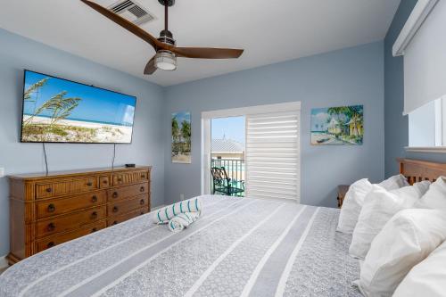 a bedroom with a bed and a dresser and a window at Best View and rooms of Harbour House at the INN in Fort Myers Beach