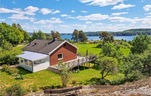 an aerial view of a red and white house with a deck at 2 Bedroom Awesome Home In Brastad in Brastad