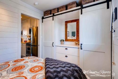 una pequeña cocina con armarios blancos y una cama en Amazing Renovation, Premium Top Floor Unit Near Downtown, Access to Hot Tubs and Firepit PM6B en Breckenridge