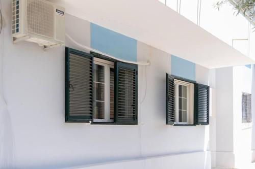a row of windows on a white building at Sea & Mountain Lukove Apartment in Lukovë