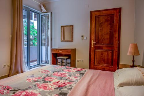 a bedroom with a bed and a door and a window at Nature View Vacation Flat in Ulcinj, Montenegro in Ulcinj