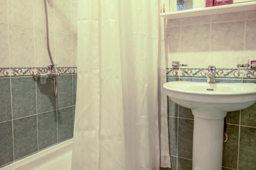 a bathroom with a sink and a shower curtain at Nature View Vacation Flat in Ulcinj, Montenegro in Ulcinj