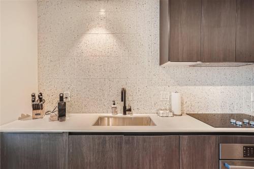 a kitchen with a sink and a counter top at Spacious 1 BR condo - Amazing views - Pool - Kitchen in Austin