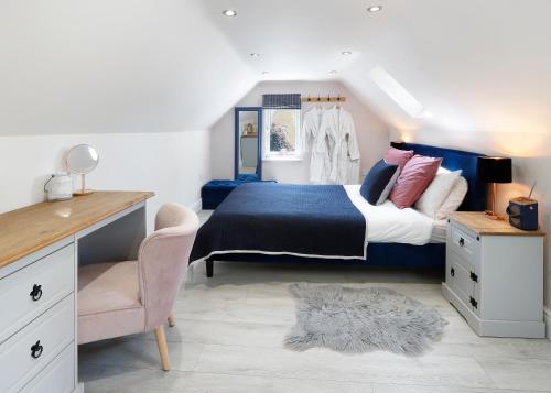 a bedroom with a large bed and a desk at Castle Hideaway in the Cotswolds in Chipping Campden