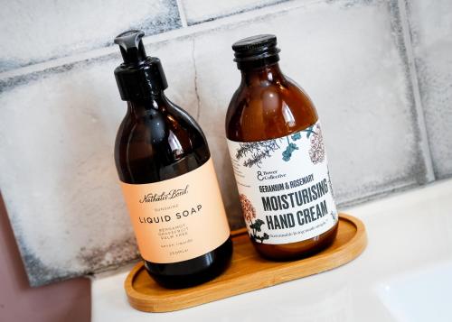 two bottles of wine sitting on a wooden shelf at Castle Hideaway in the Cotswolds in Chipping Campden